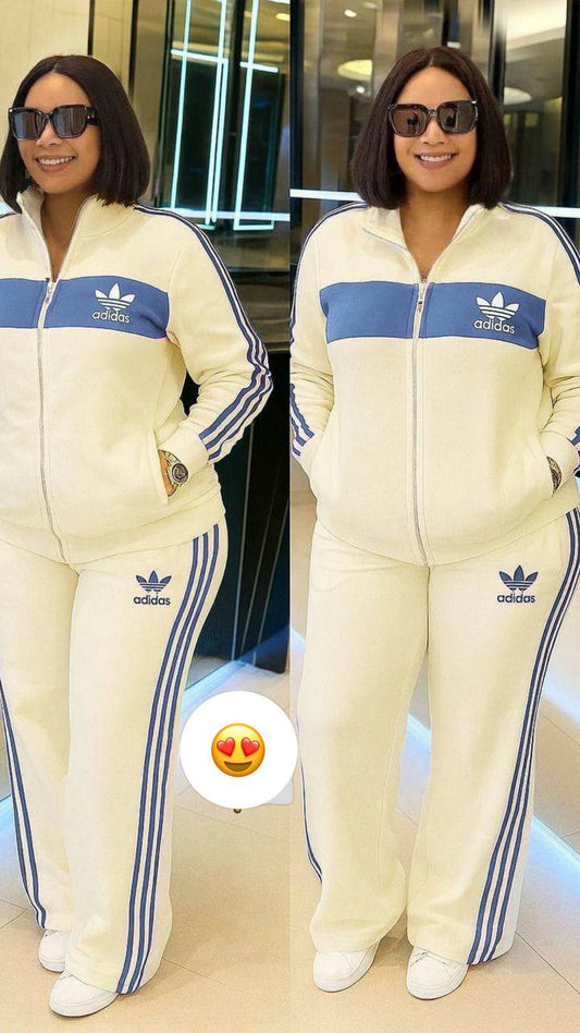 A cream Adidas tracksuit with blue accents.